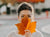 Girl holding leaf over face. Autumn skincare tips.